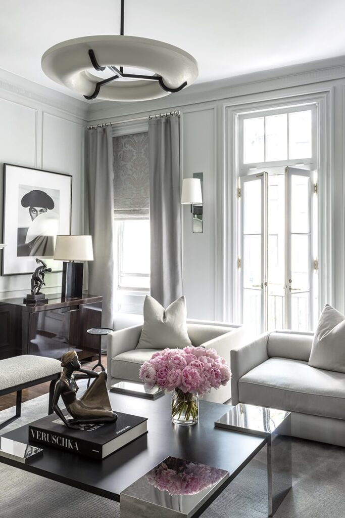 Elegant traditional living room with classical millwork trim showing floor to ceiling drapes