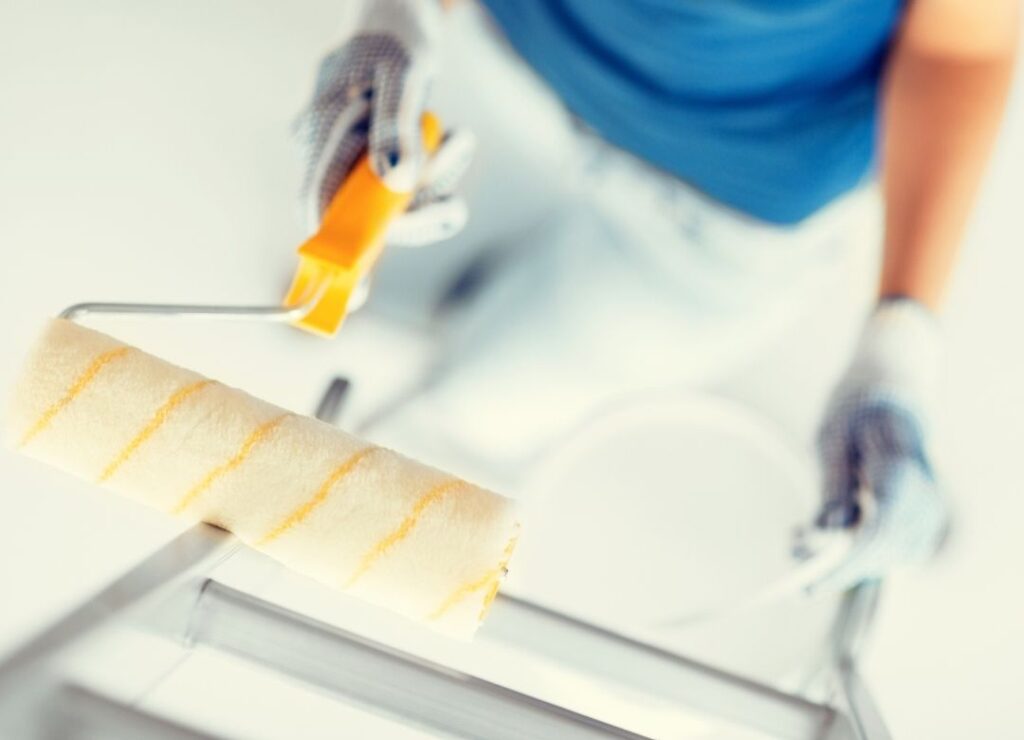 person working with a paint roller