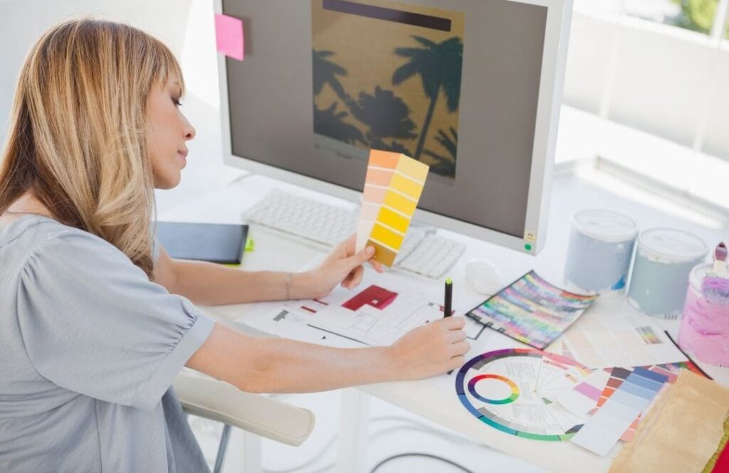 woman looking at two paint chips